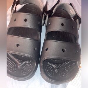 Kids black croc sandals.